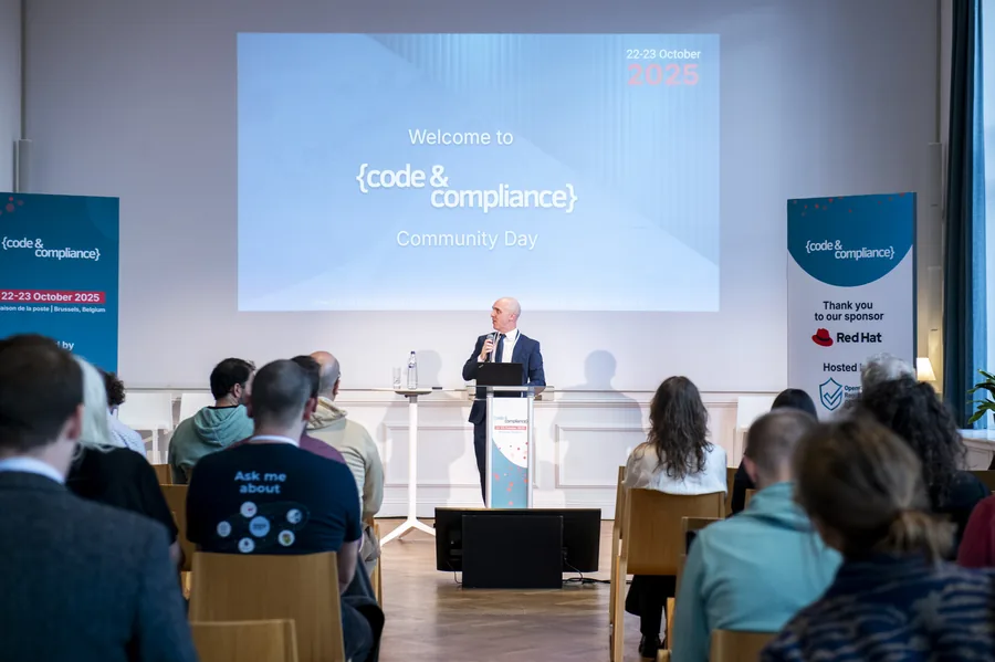 A speaker from the Eclipse Foundation welcoming an audience to the Code and Compliance Community Day.